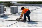 Roof repair crew working on commercial flat roof near Mountain View